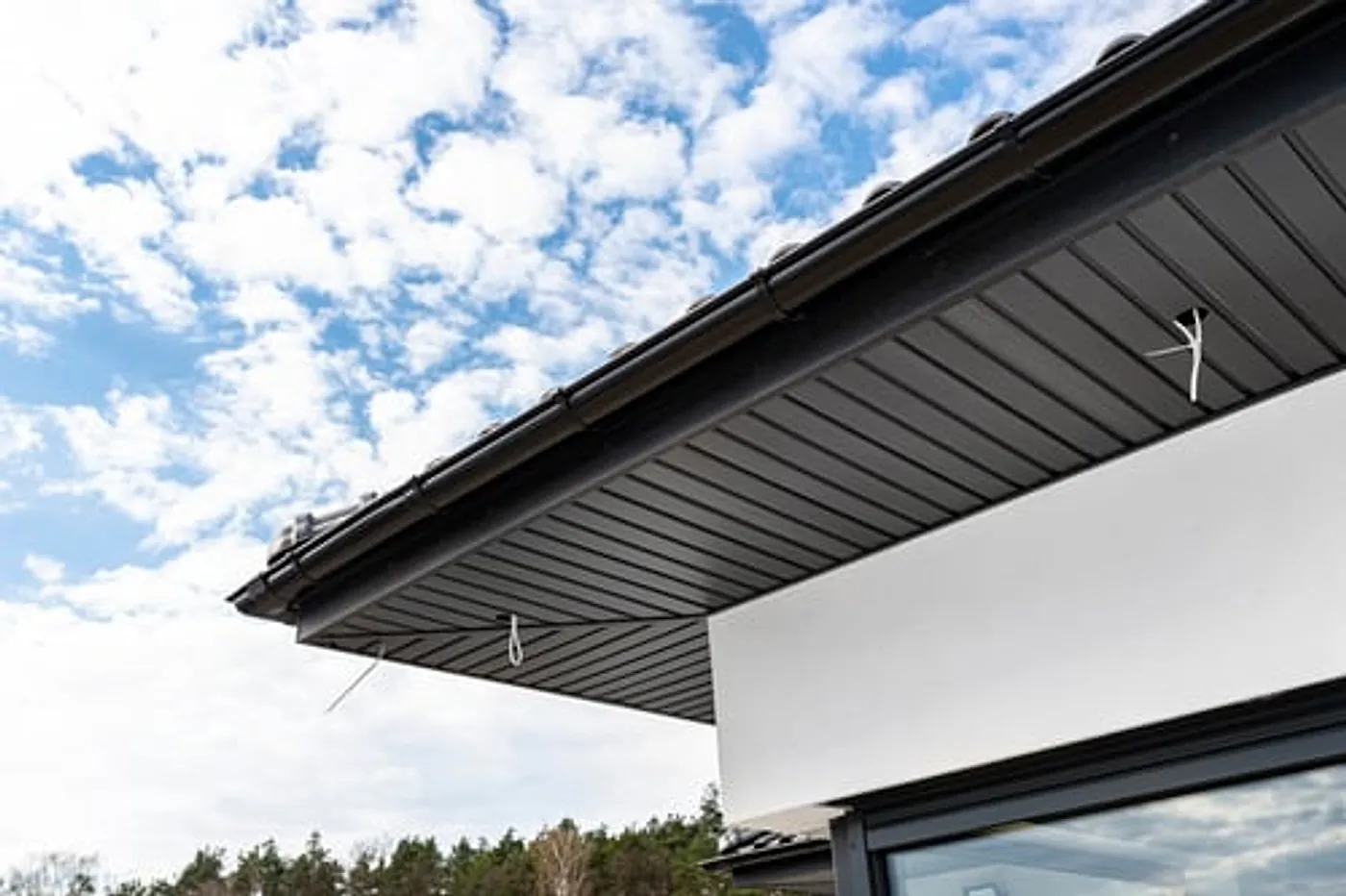 Modern seamless gutter and fascia detail along the edge of a residential roof